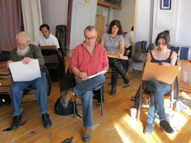 Artists sketch Jillian Page in a Figure Drawing workshop in Montreal on Oct. 20, 2013. Colette Coughlin, one of the workshop organizers, is seen sitting in the background, in grey top. Photo taken by Jillian Page during a pose.